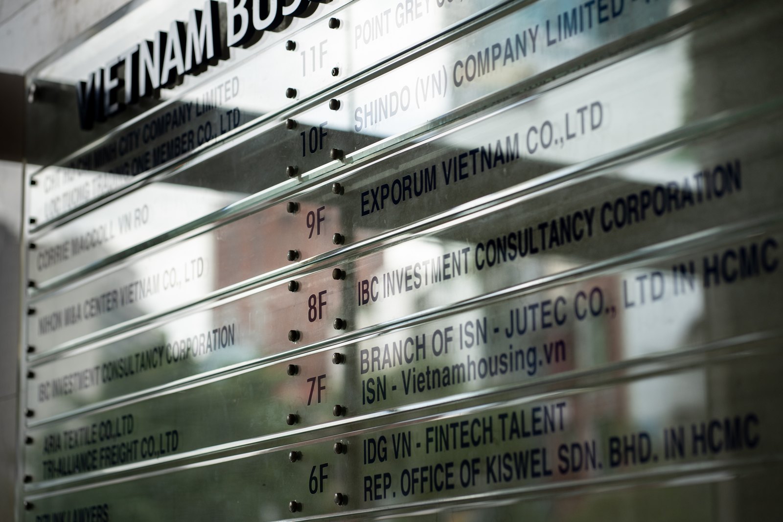 Building directory at the Vietnam Business Center listing IBC Investment Consultancy Corporation on the 8th floor, Phường Sài Gòn, Ho Chi Minh City
